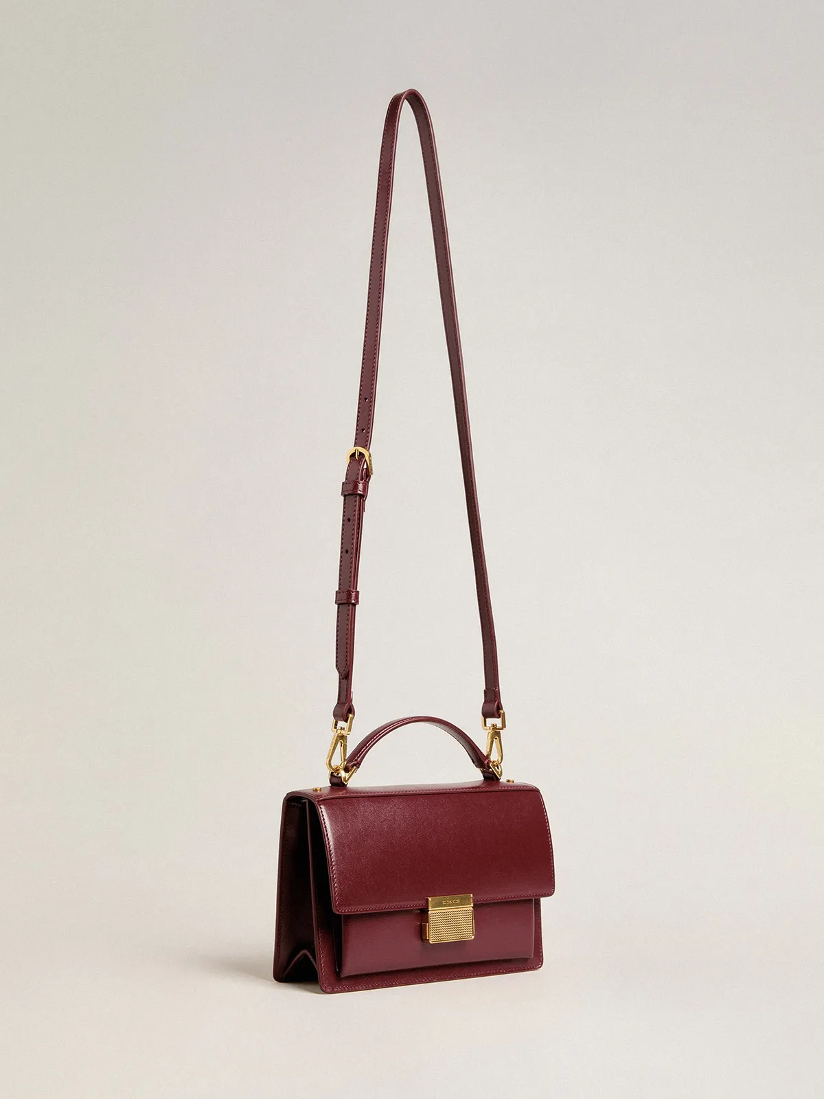 Venezia Bag in burgundy boarded leather with gold details