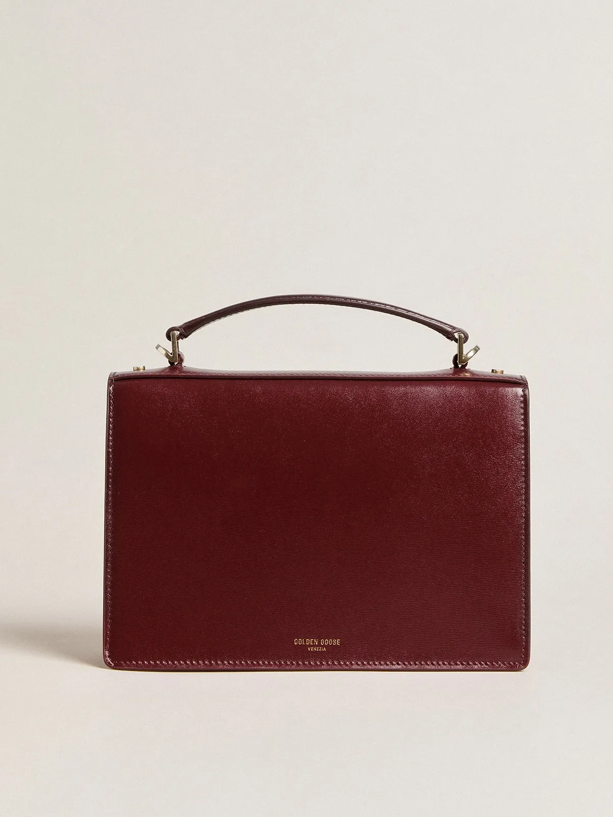 Venezia Bag in burgundy boarded leather with gold details