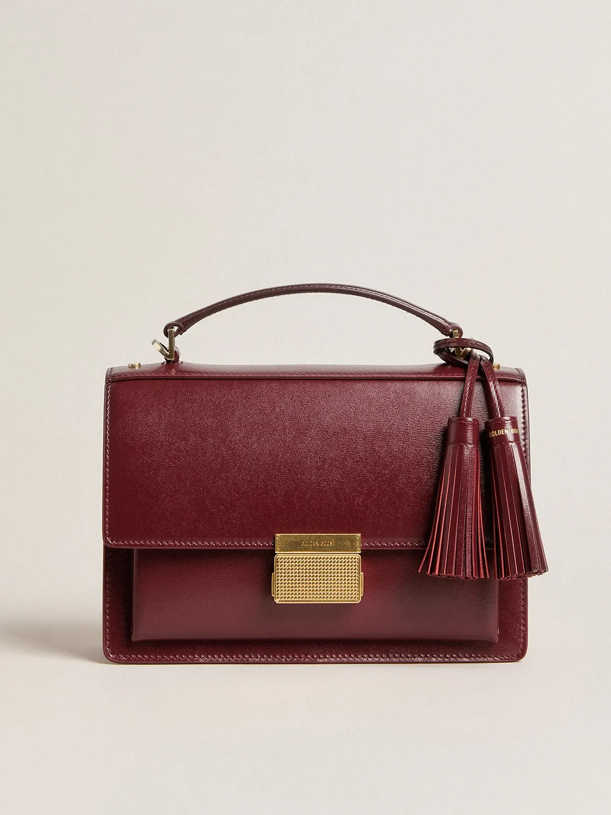 Venezia Bag in burgundy boarded leather with gold details